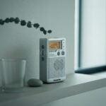 DT-250 실버 Propped against a textured off-white wal
